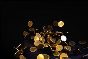 Herunter fallende Goldm&uuml;nzen auf schwarzem Hintergrund