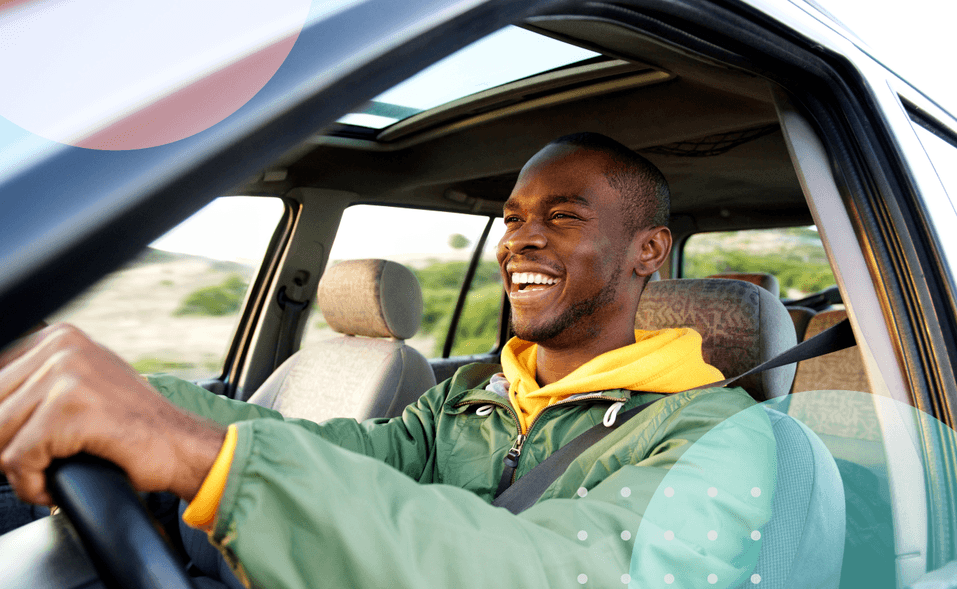 Happy man smiling and driving