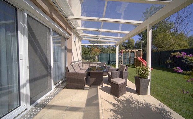 Überdachte Terrasse mit hellem Steinboden