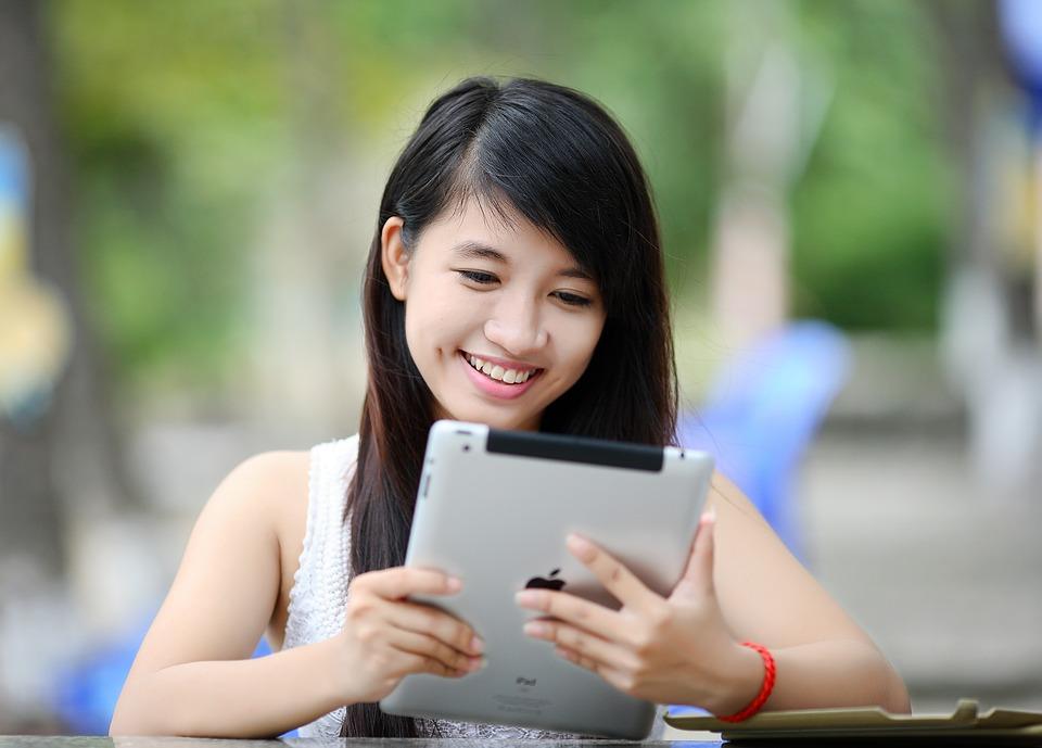 Girl using tablet Girl reading a review