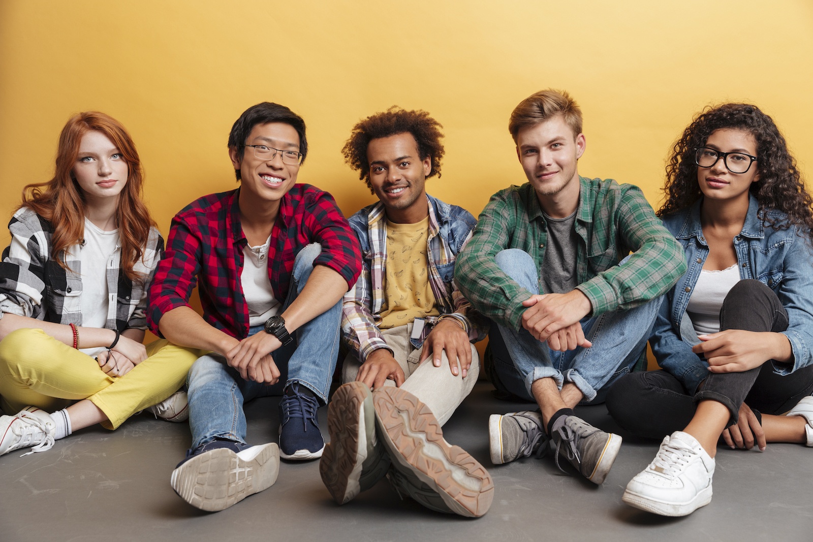 group-of-people Group of people sitting together over yellow background