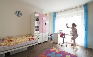 Gro&szlig;es lichtdurchflutetes Kinderzimmer mit dunklem Holzfu&szlig;boden