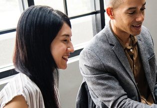 man and women smile talking about community
