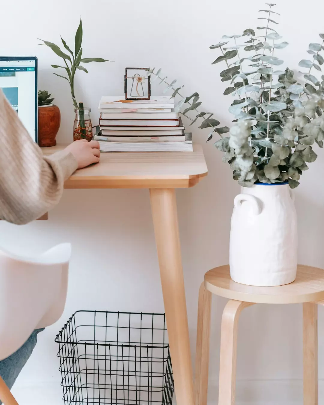 desk with laptop and pink flowers