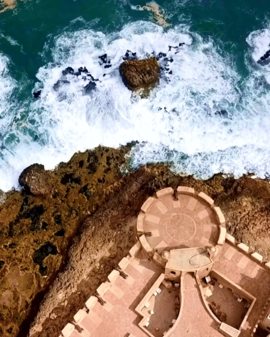 3 slide gif video highlighting Portugal, including a trolley car going up the street, a castle on the coast, and a view of white buildings with tile roofs.