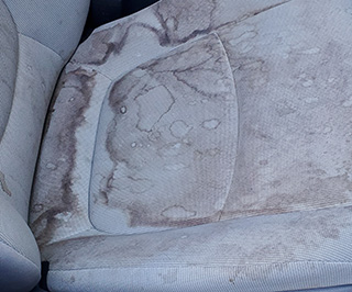 Worn car interior before Oceanside mobile detailing restoration