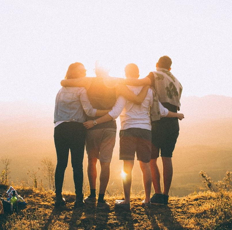 group of people looking into the distance with the sun shining on them