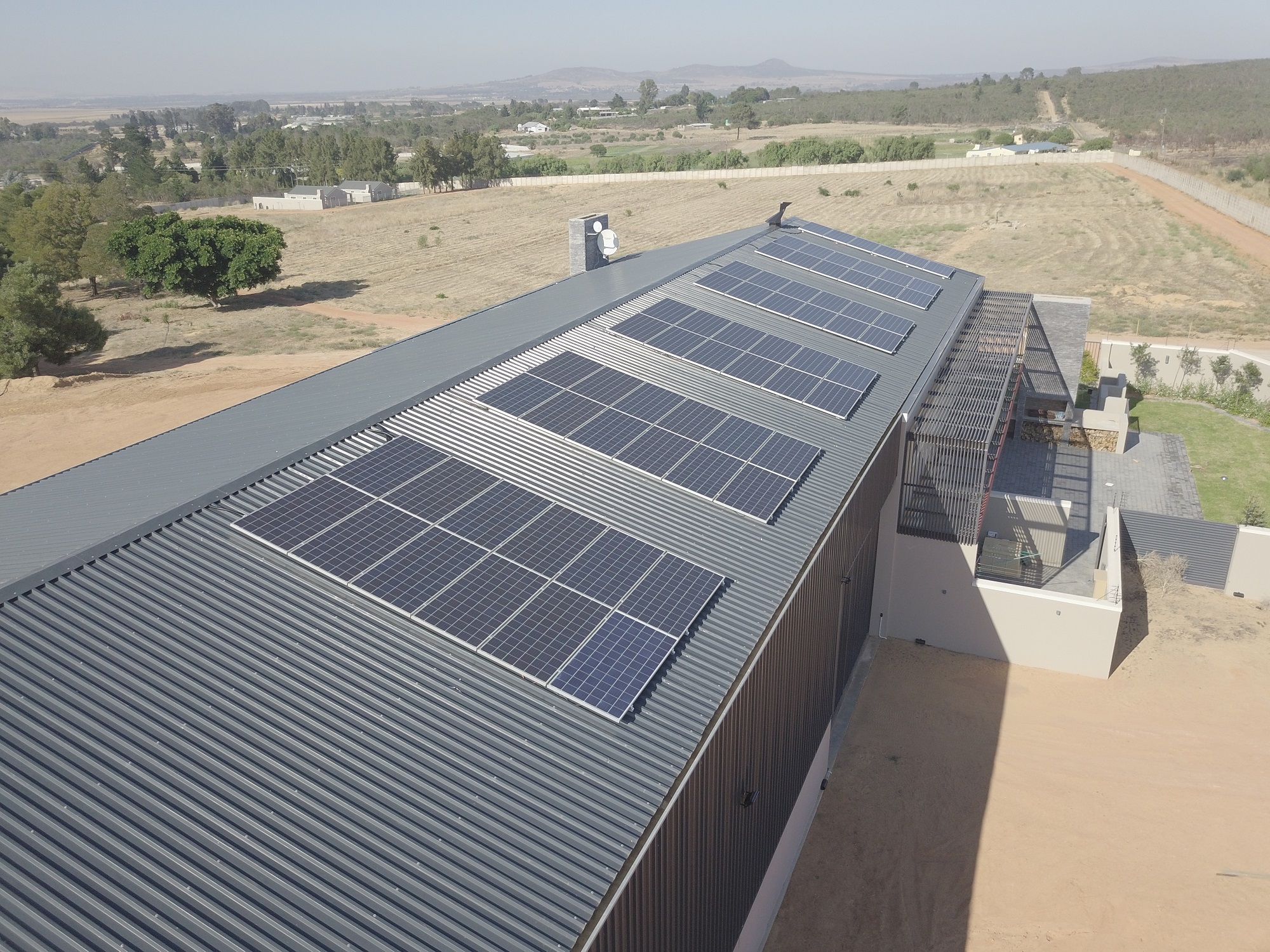 Aerial view of a large rooftop solar panel installation by Max Yield Energy