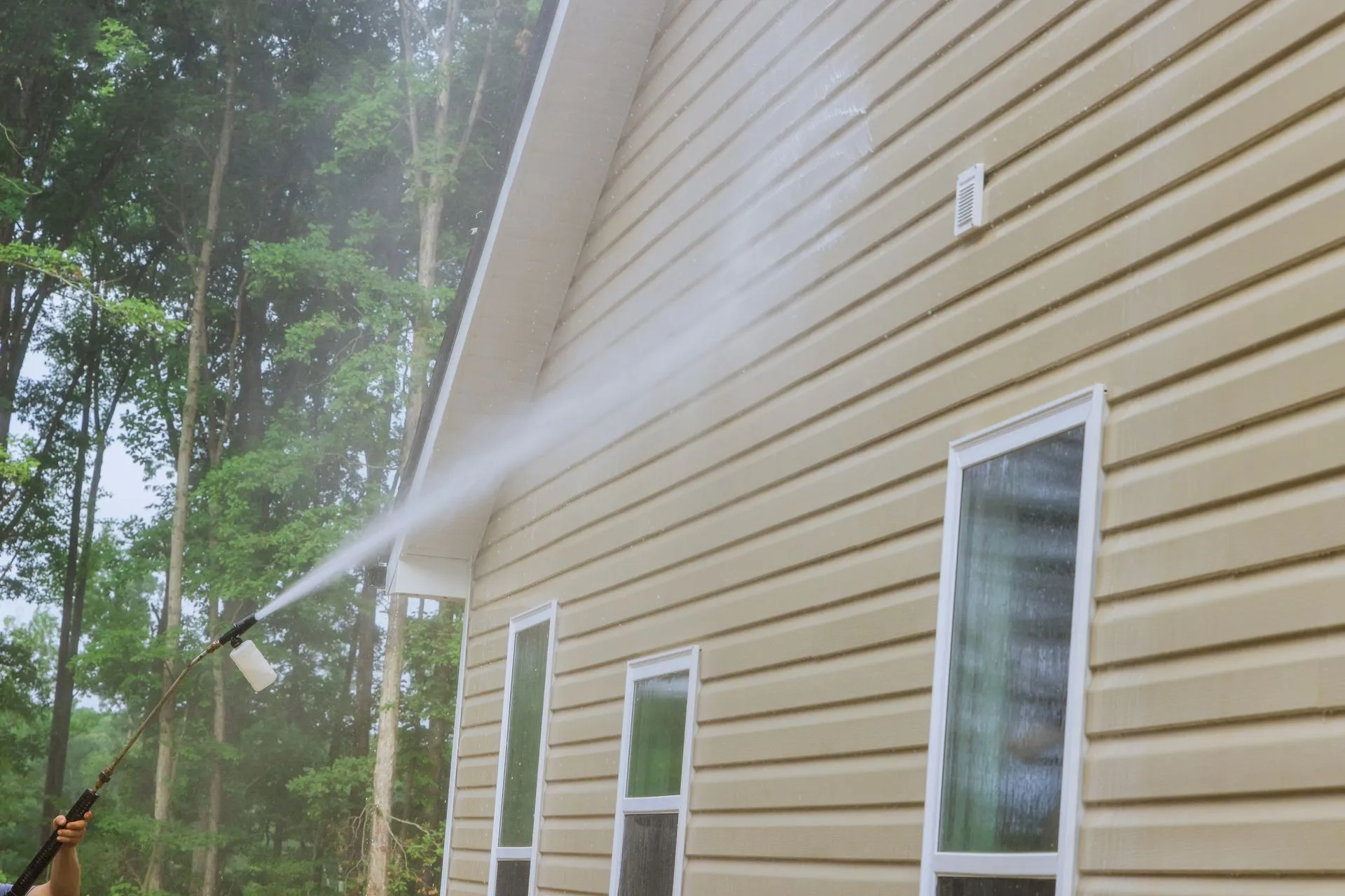 Residential exterior wall being soft washed
