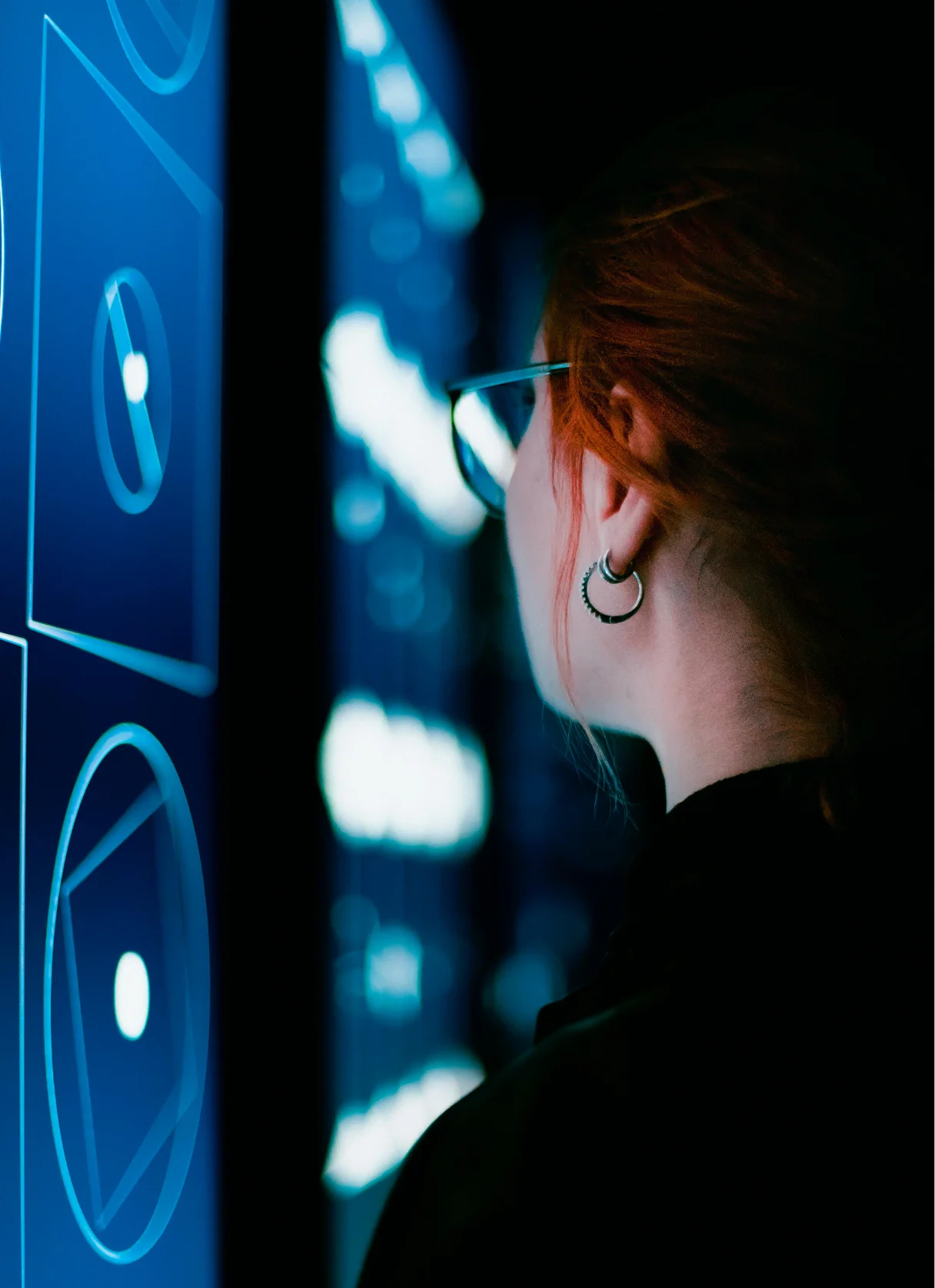 A female PoC sitting in front of a laptop smiling