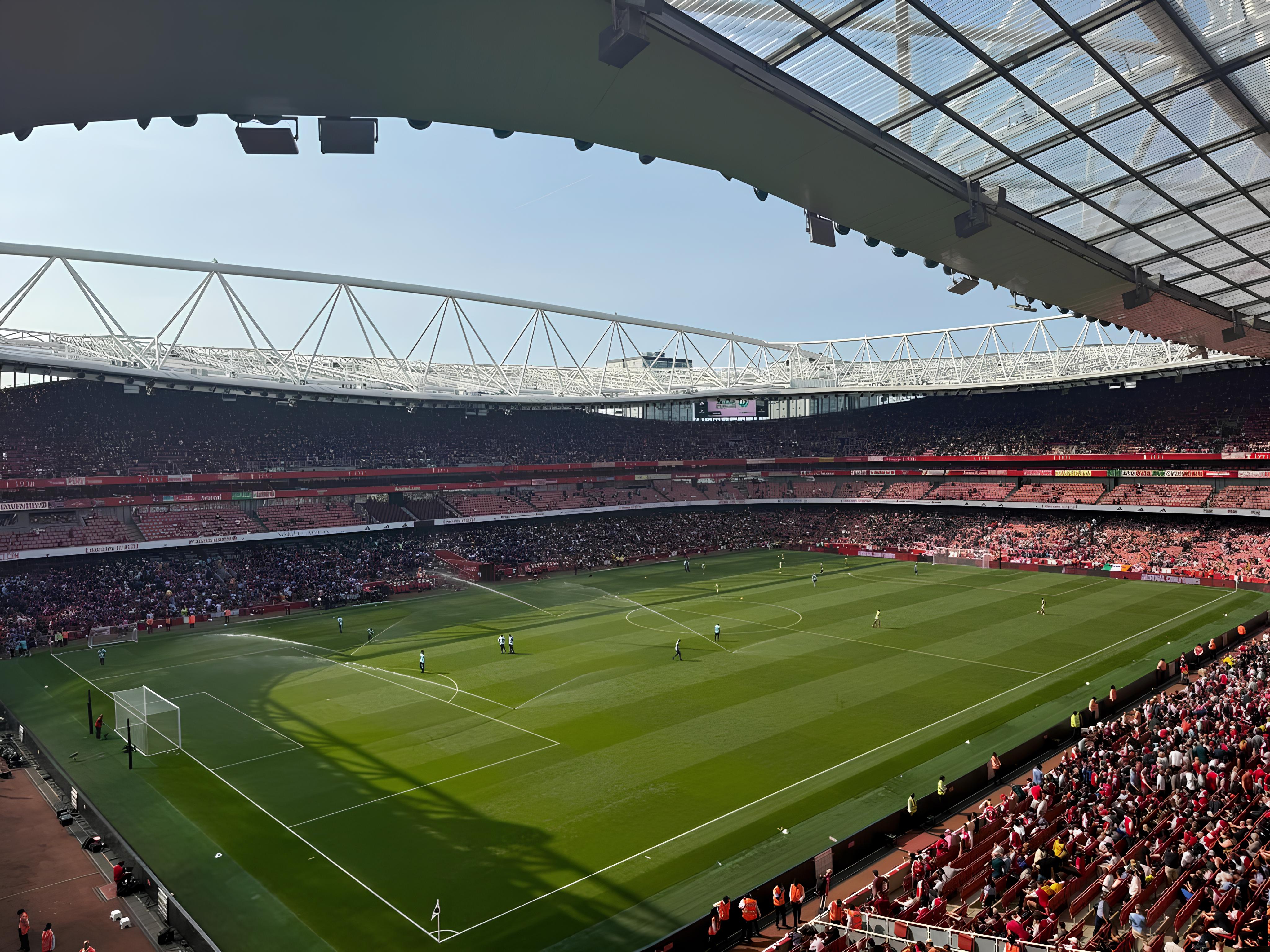 Sunlit view across a packed Emirates Stadium during an Arsenal match