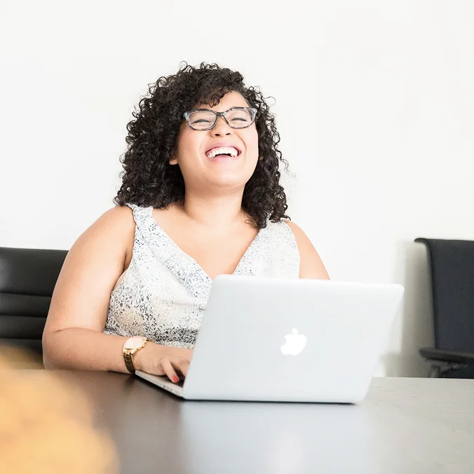Male, bearded PoC smiling into the camera