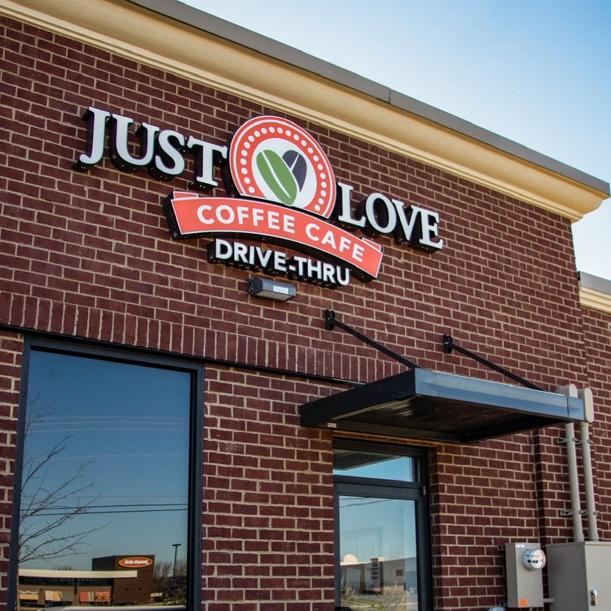 Close crop of the Just Love Coffee Cafe interior and cafe branding