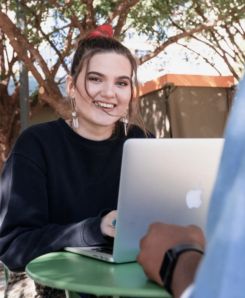 A person working on a laptop outside