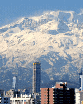 3 slide gif video highlighting Chile, including a person on a mountain at sunrise, the cityscape and mountains, and a temple building.