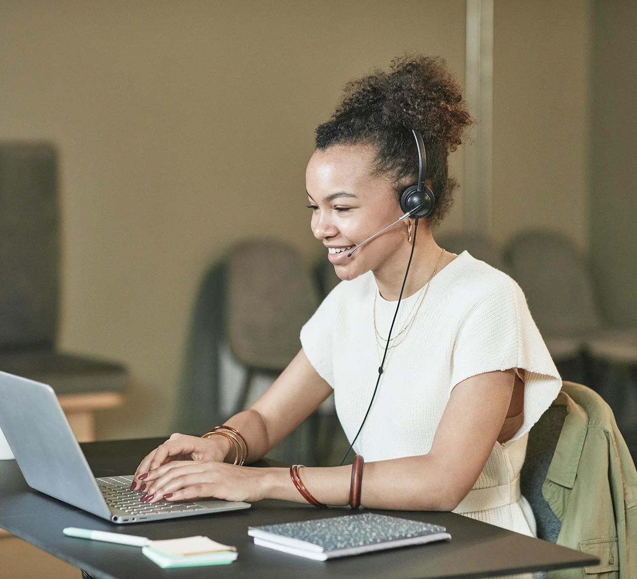 Male, bearded PoC smiling into the camera