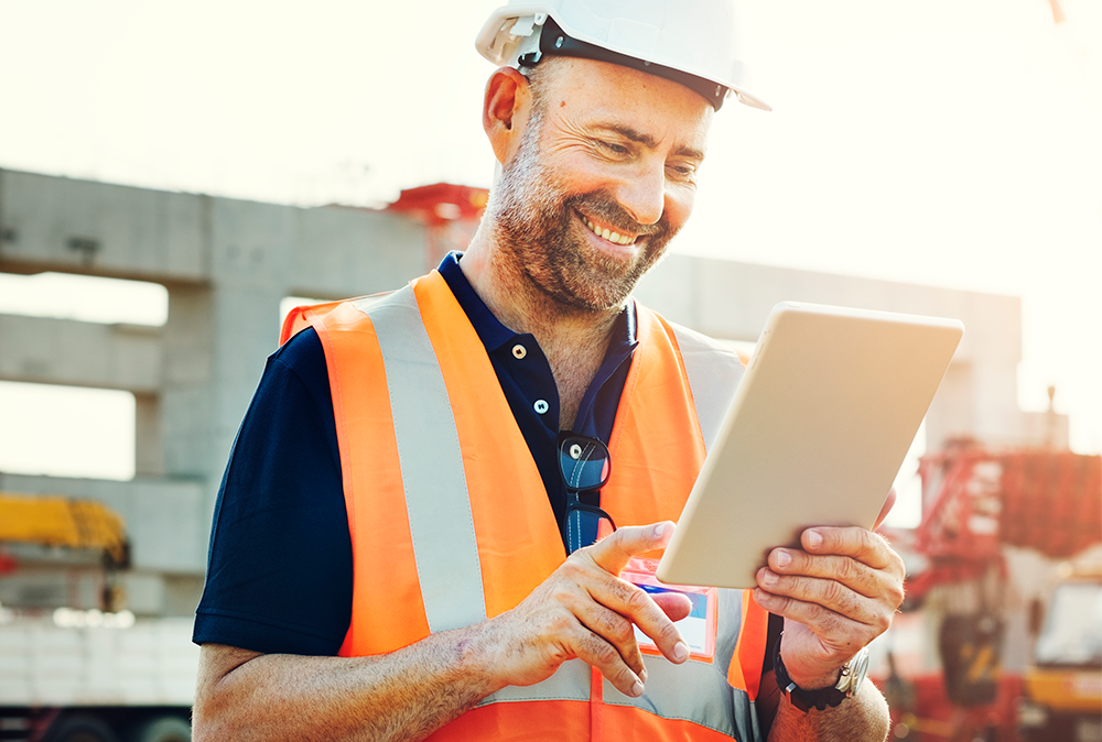 Happy worker using a tablet