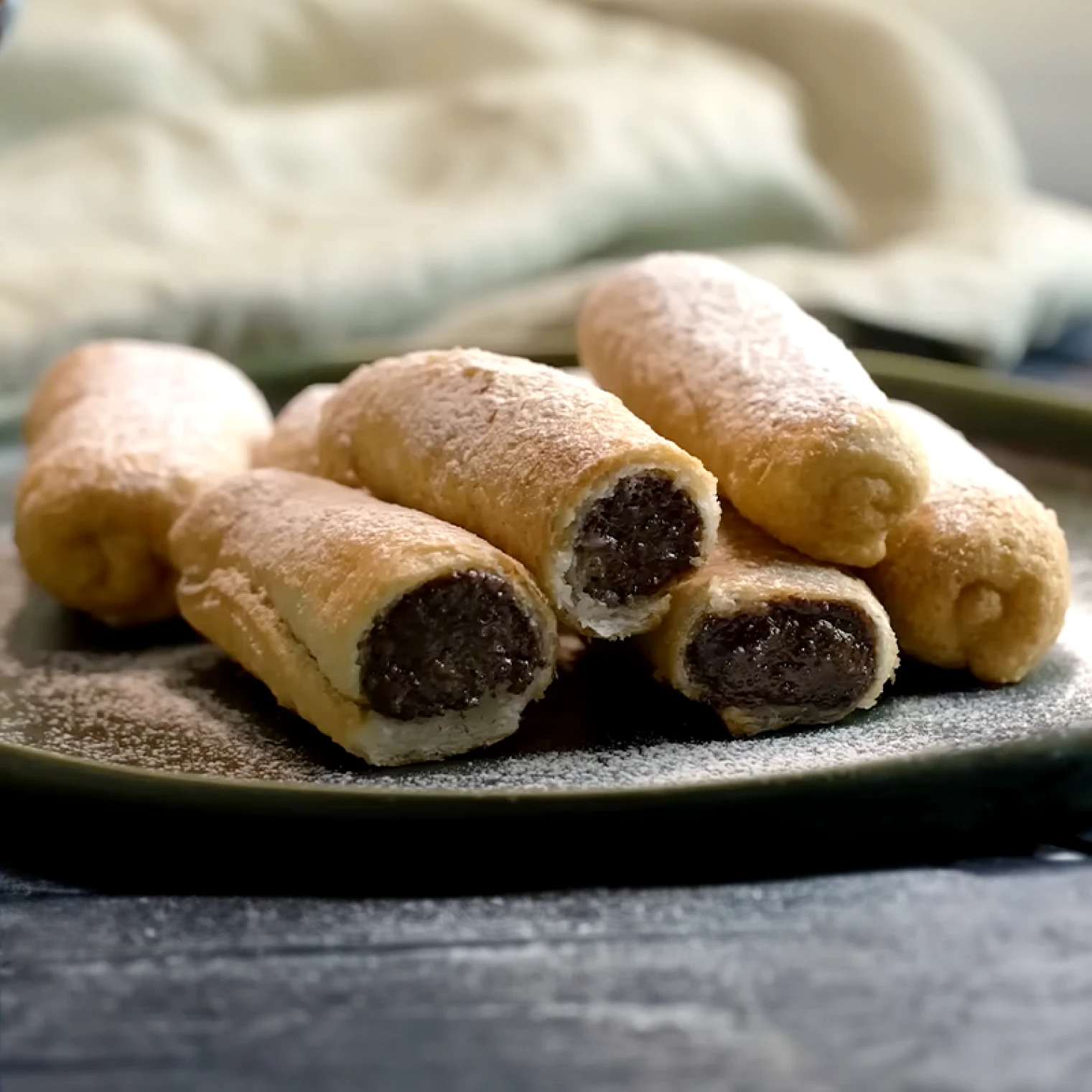 Kilka zwiniętych makowik&oacute;w na talerzu