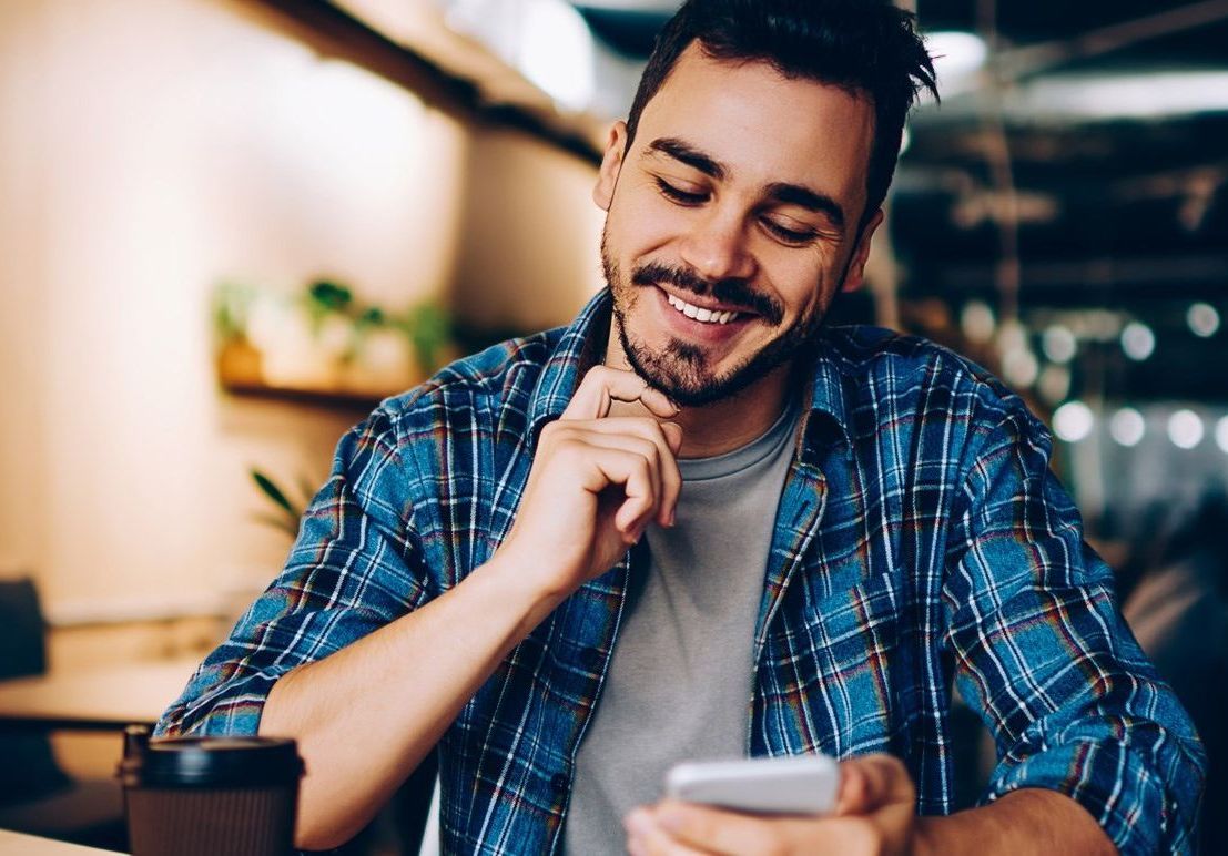 Happy man using a phone