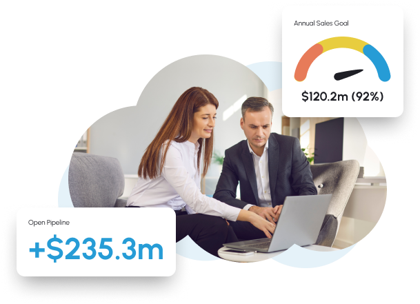 An image of a man and woman on a computer surrounded by clouds representing data