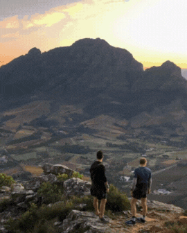 3 slide gif video highlighting Spain, including a person surfing, the historic city streets at night, and a historic fountain in the city.