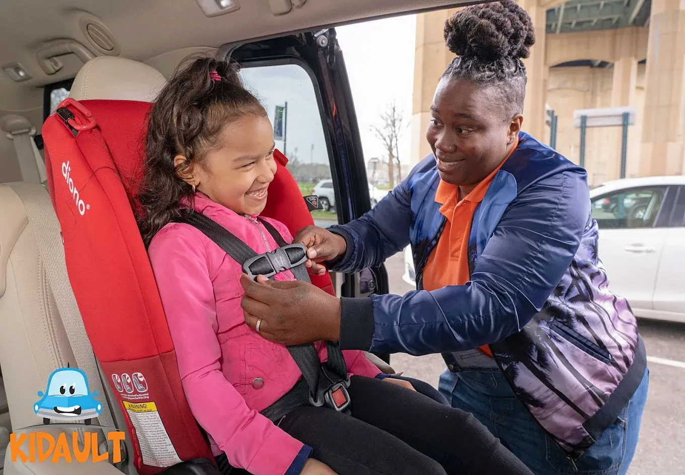Kidault driver putting a girl safely into a carseat.