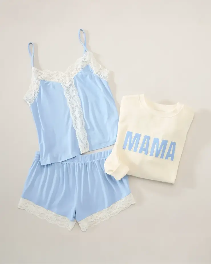 Green floral sleeveless dress draped over a modern chair and styled with a brown belt, light blue blazer, and sunglasses on the seat. The outfit is arranged as a complete warm weather look against a neutral background to showcase the styling pieces together.